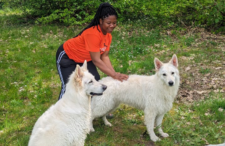 Larissa Faiza Kongsnso with two big dogs.