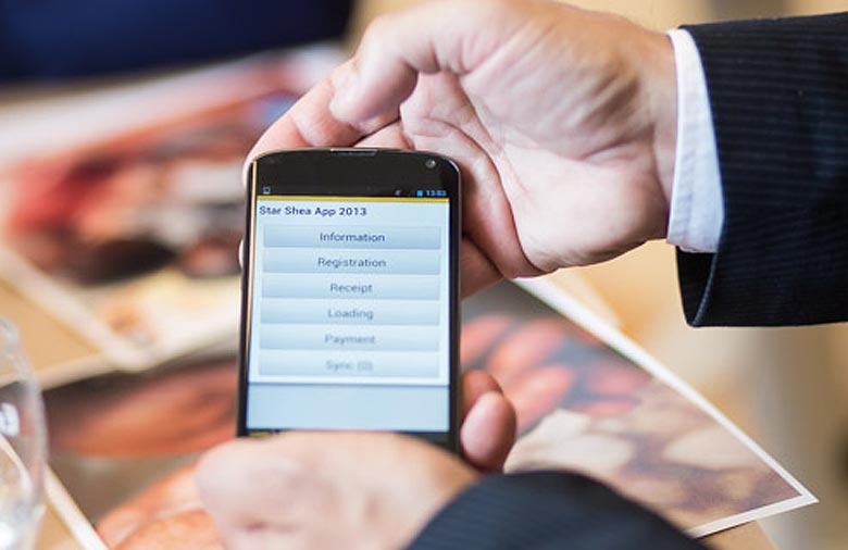 Zwei Hände halten ein Smartphone, auf dessen Bildschirm die „Star Shea App 2013“ angezeigt wird. Foto: Christian Klant.